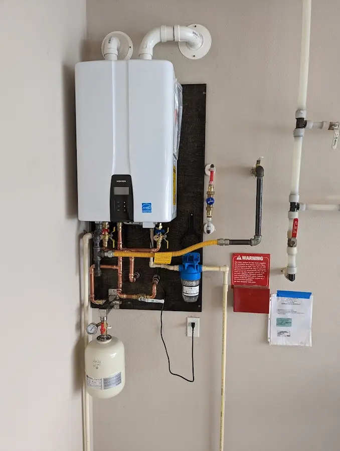 Professional plumber installing copper piping in a Orchard Mesa home